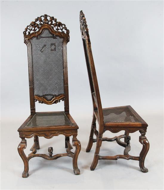 A pair of 17th century Flemish walnut hall chairs, W.1ft 8in. H.4ft 3in.